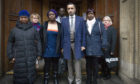 Solicitor Aamer Anwar (centre) arrives at the Crown Office in Edinburgh, with family members of the late Sheku Bayoh in November 2019.