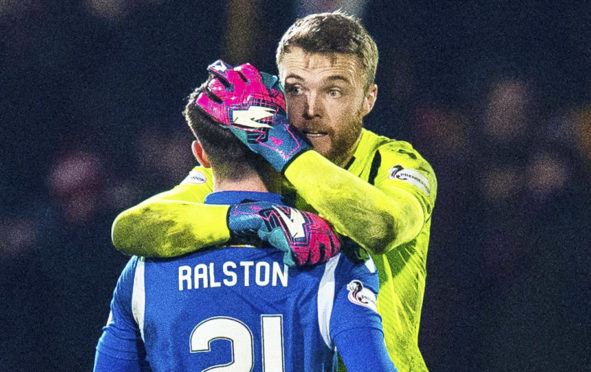 Zander Clark hugs Anthony Ralston at the full-time whistle.