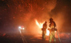 Firefighters battle a wildfire in Riverside, California.