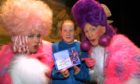 Laura Muir of the 30th Dundee Guides with ugly sisters Daisy - Ewan Campbell (left) and Dandylion - Roger Buist, of the Downfield Musical Society after making her promise on stage at the Whitehall Theatre in 2005