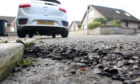 Courier News. Angus story. Picture shows; potholes and cracks in the road in Ireland Street (beside junction with Carlogie Road) for story about Angus pothole hotline. Monday, 31st July, 2017.