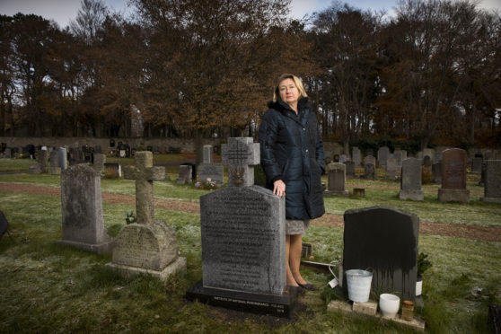 Anna Pawliszewska at the grave of her great grandfather, Polish General Mikolaj Osikowski in Hayfield Cemetery Kirkcaldy