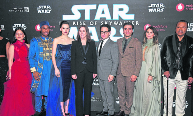 From left: Cast members Kelly Marie Tran, John Boyega, Daisy Ridley, Kathleen Kennedy, director JJ Abrams, Oscar Isaac, Keri Russell and Billy Dee Williams at the London premiere. Shutterstock.