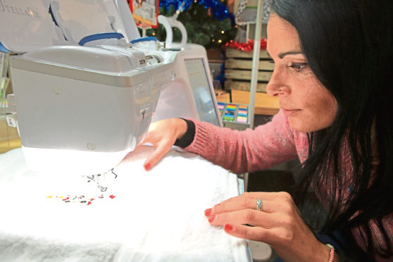 Gayle casts a beady eye over her embroidery at Karelia House.