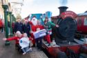 From left, Samantha Lindsay – Dorward (DSSB), Orlaith Lindsay – Dorward (aged 8), Andy Pegg (Caledonian Railway Events and Marketing Director), Robert Thorburn (Openreach Scotland Partnership Director), Santa and his helpers.