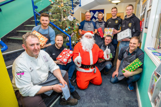 Jeremy Wares (left) alongside members of Perthshire Rugby club and Santa Claus.