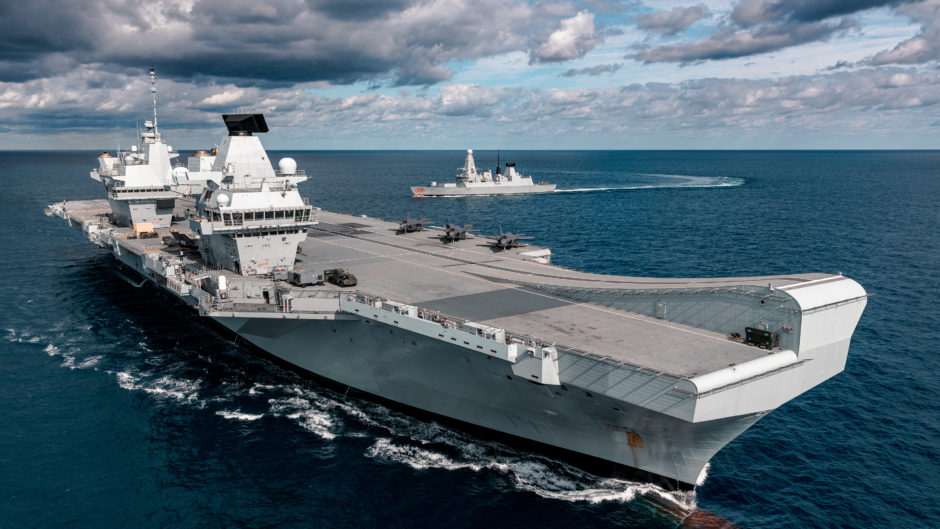 UK F-35 Lightning jets onboard Britain's next generation aircraft carrier, HMS Queen Elizabeth for the first time. HMS Dragon, a Type 45 Destroyer is also seen in the background.