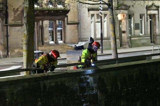 Emergency officers conduct a search of the River Tay in Perth.