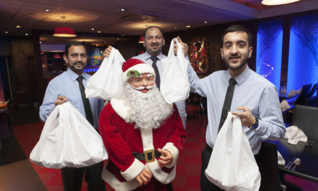 Manzil staff Saved Khan, MZ Abbas and  Gulam Rasool will be handing out free Christmas meals on December 24.