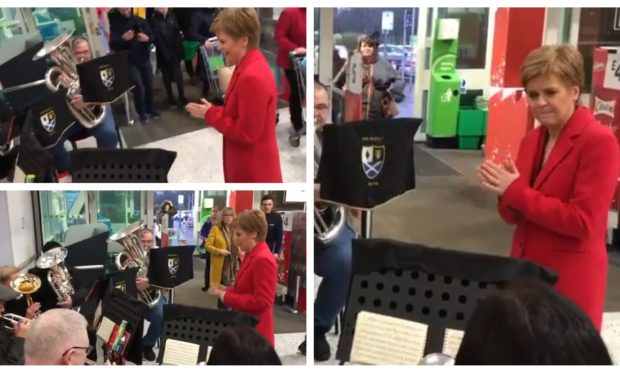 Nicola Sturgeon conducts the brass band at the Asda in Dunfermline.