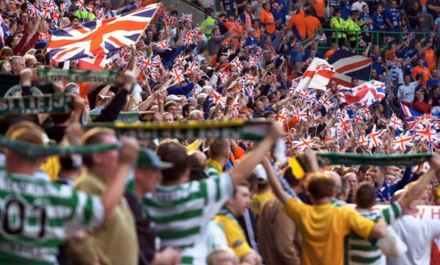 Rangers and Celtic fans taunt each other.