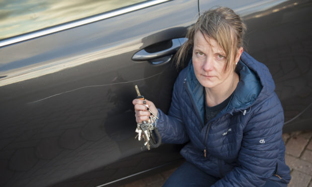 Nikki Murray, a volunteer driver for Contac the Elderly, beside the vandalism.