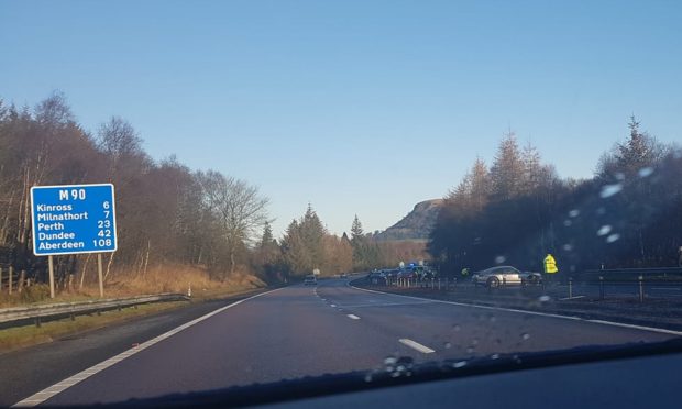 The Porsche hit the central reservation on the M90 near Kelty.