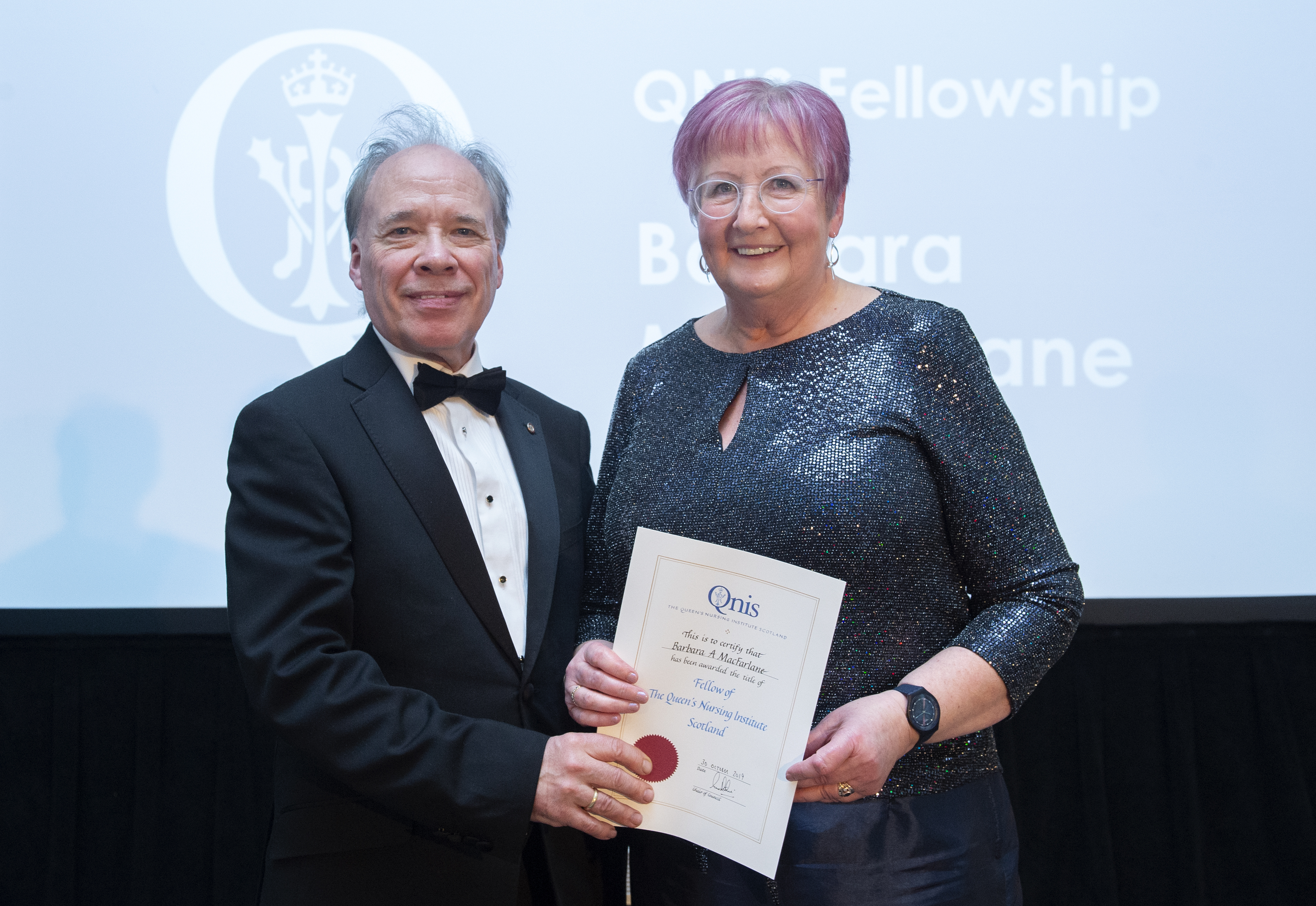 Barbara MacFarlane receiving her award from Professor Sir Lewis Ritchie.