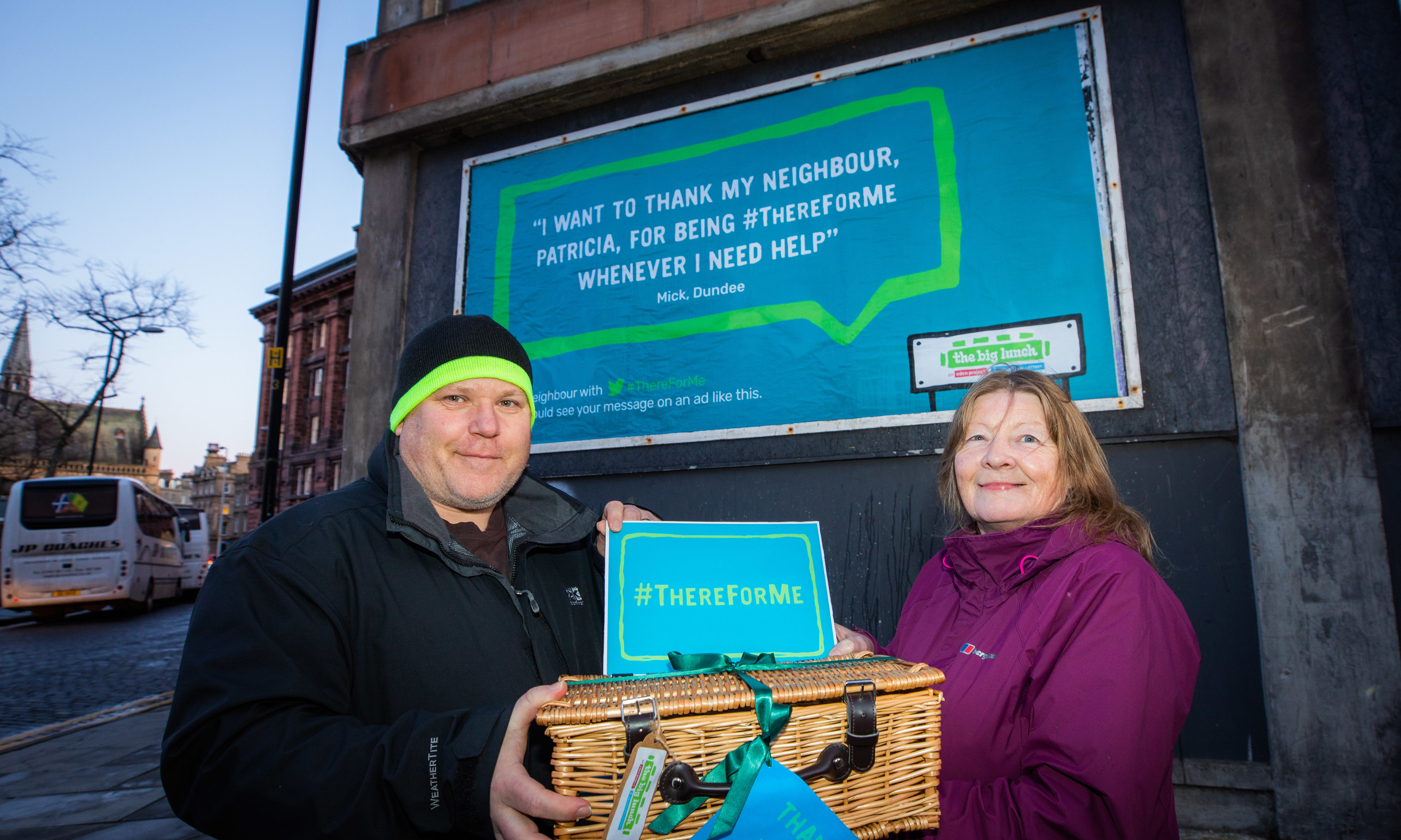 Mick Vine and Patricia Phinn with their billboard in the background.