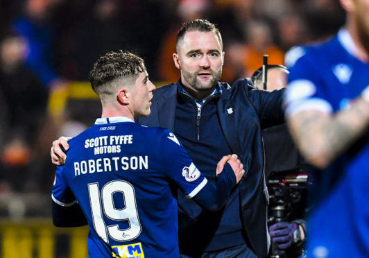 Fin Robertson is congratulated on his display by boss James McPake at full-time in the derby.