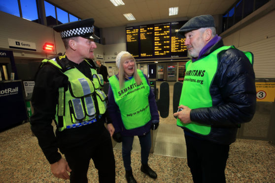 Samaritans Emma and Chris with PC David McDonnagh of the British Transport Police.
Picture: Phil Hannah.