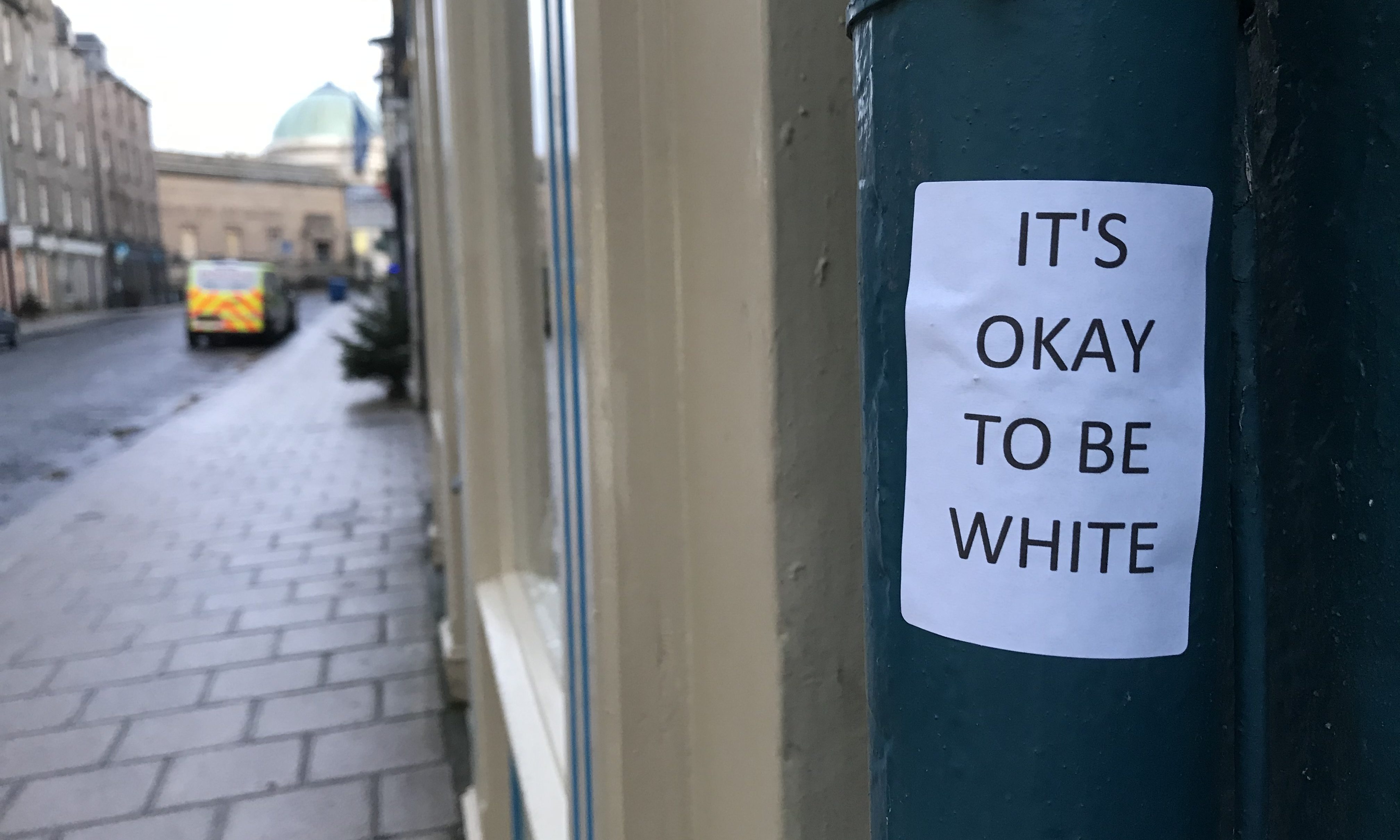 Stickers reading "Its okay to be white" have appeared around Perth.