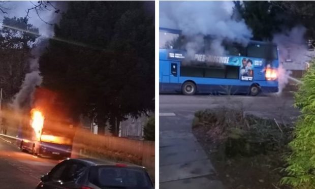 The bus goes up in flames outside Queen Anne High.