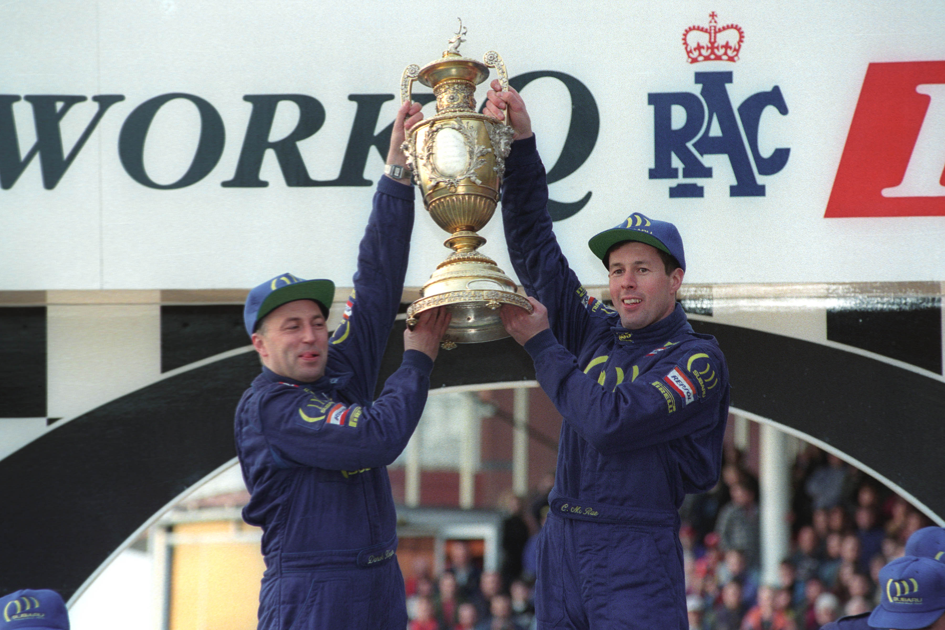 Colin McRae and co-driver Derek Ringer celebrate their world title in 1995.