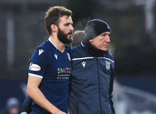 Dundee's Jamie Ness goes off injured on Saturday.