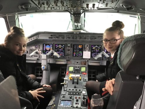 Georgia and Melissa onboard their Loganair flight to East Midlands.