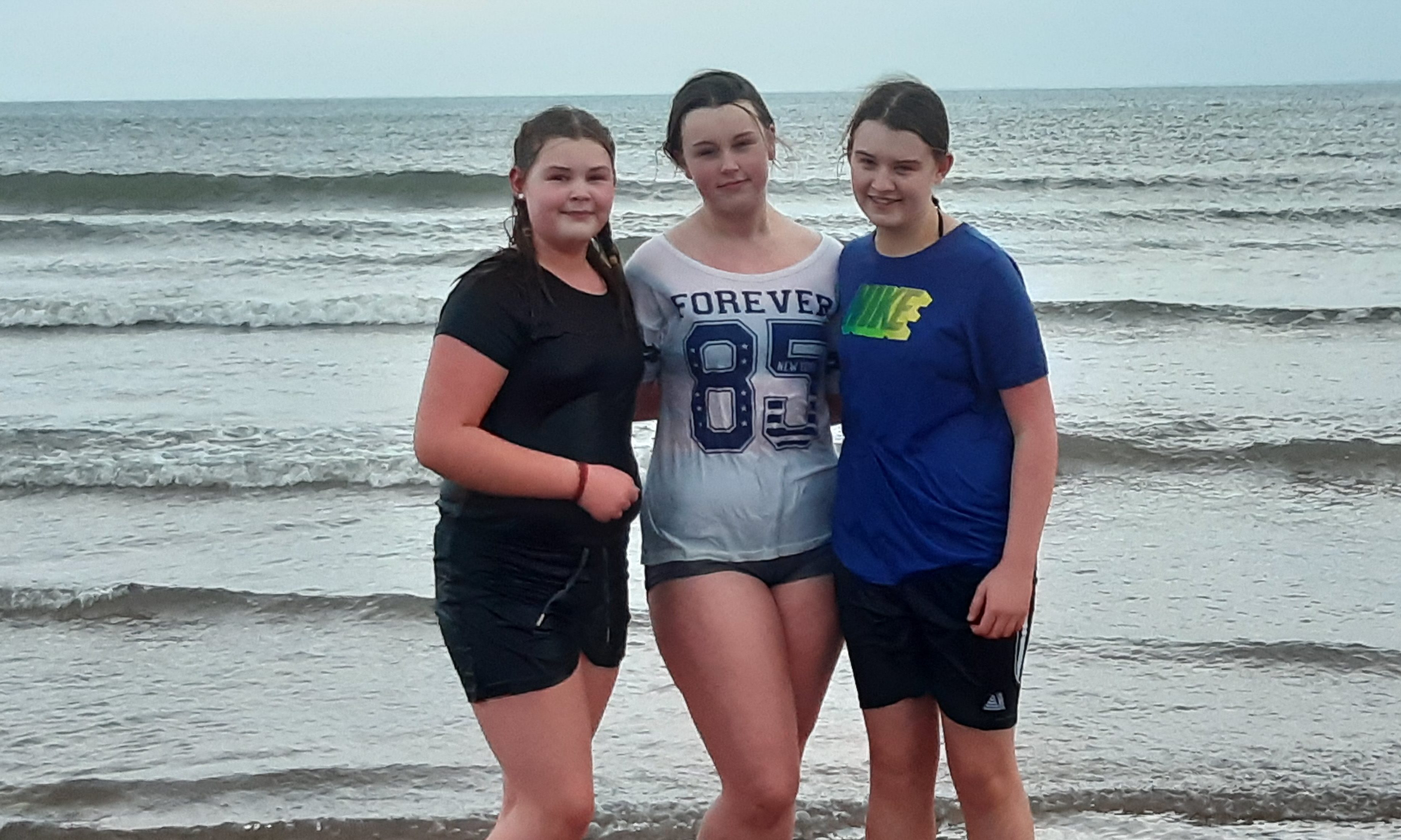 Amelia Peffers, Lois Young and Ellie Peffers spent 26 minutes in the waves at Carnoustie to take the dook prize.