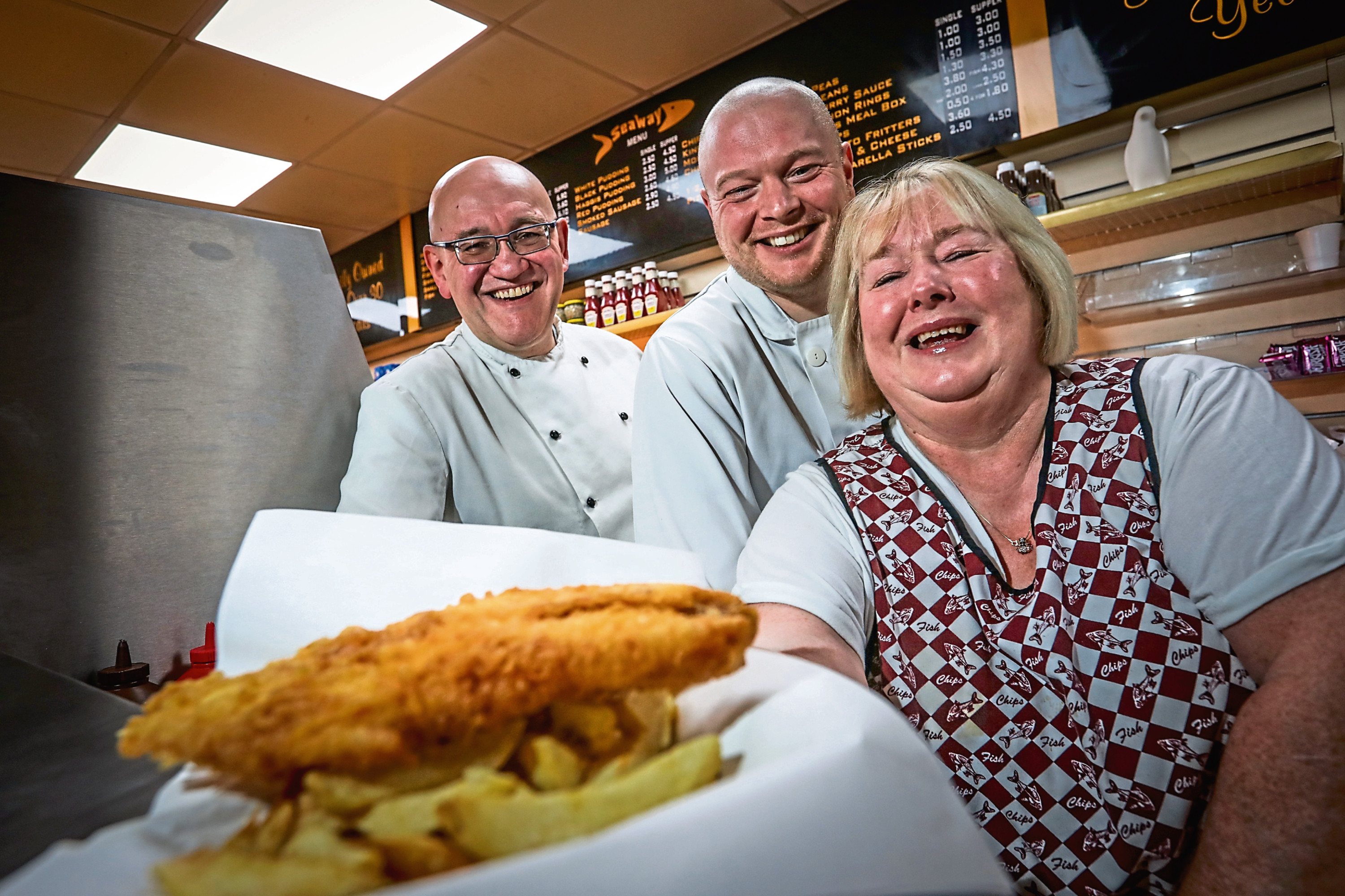 Left: Bert Roncone, Callan Bruce and Margaret Short, who has worked at the chip shop for 35 years.