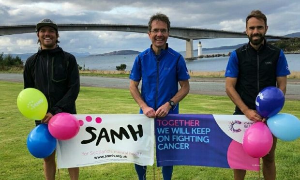 Dr Matthews, centre, was joined by sons Cameron, left, and Gregor, right, as they ran 87 miles across the Scottish Highlands in aid of Cancer Research UK.
