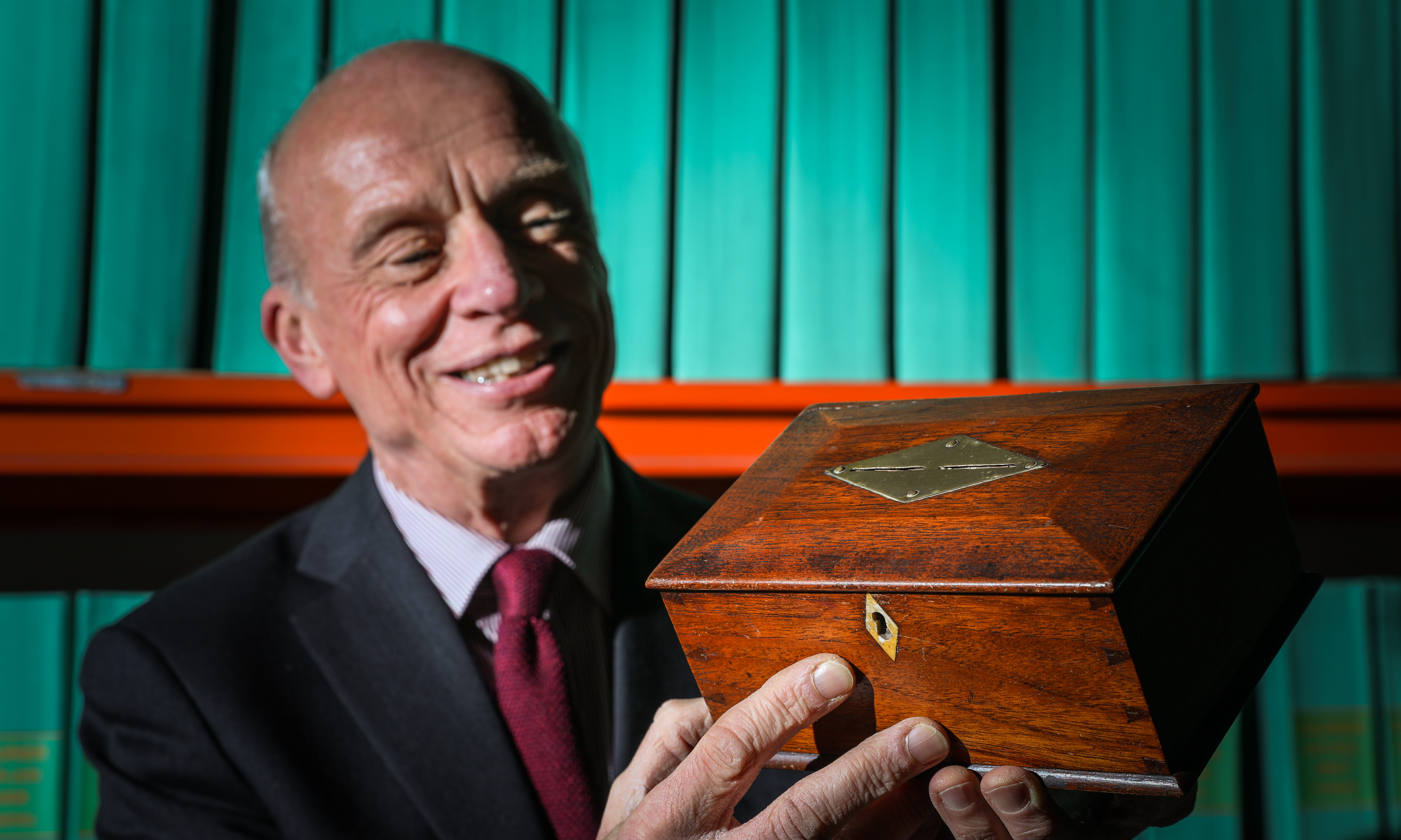 Journalist and Historian Norman Watson with a money box made from the wood of one of the Tay Bridge Disaster train carriages.