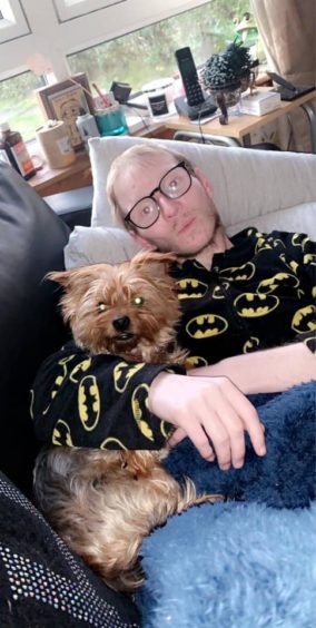 Ross Scott with his mum's dog, Koko.