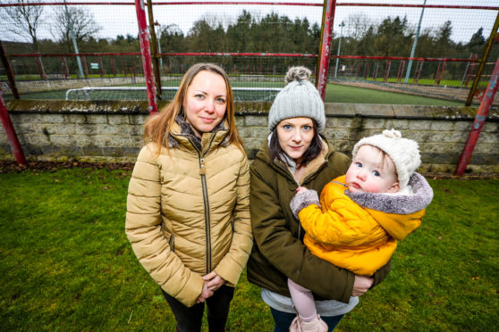 Steph Erskine and Ann-Marie Black with baby Sophie at the all weather pitch where the fence is being vandalised to gain access