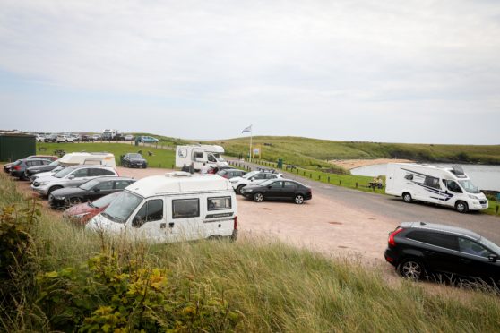 Campervans and cars filling up the car park and roadside as tourists arrive in campervans to enjoy Fife.