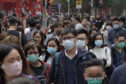 People wear masks on a street in Hong Kong,