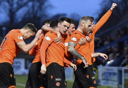 The United players celebrate with Mark Connolly.