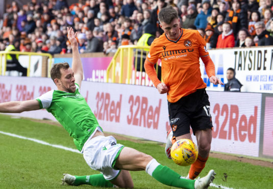Hibernian's Steven Whittaker challenges Dundee United's Jame Robson.