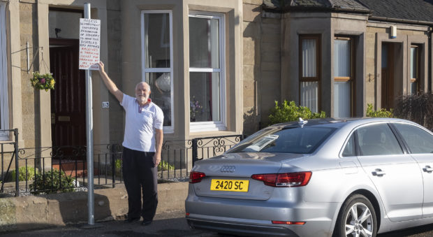 Alexander Cowie, 80, outside his home.