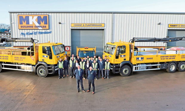 MKM Building Supplies Dundee branch directors Barclay Scott and Ross MacGregor with staff.