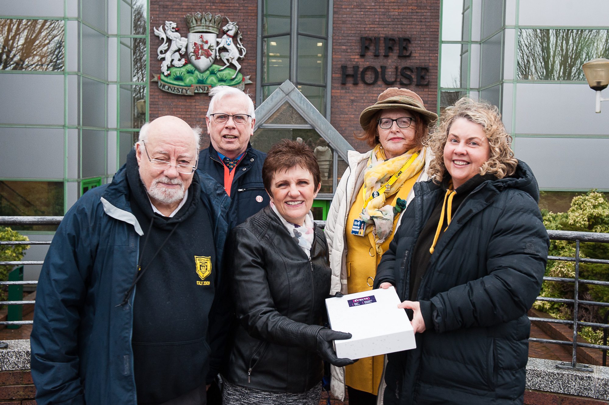 Bob Main, vice chairman, and Bridget Fraser, chairwoman, of Burntisland Amateur Swimming Club, hand the petition to Cllr Judy Hamilton, with Cllr Gordon Langlands, and Cllr Lesley Backhouse behind