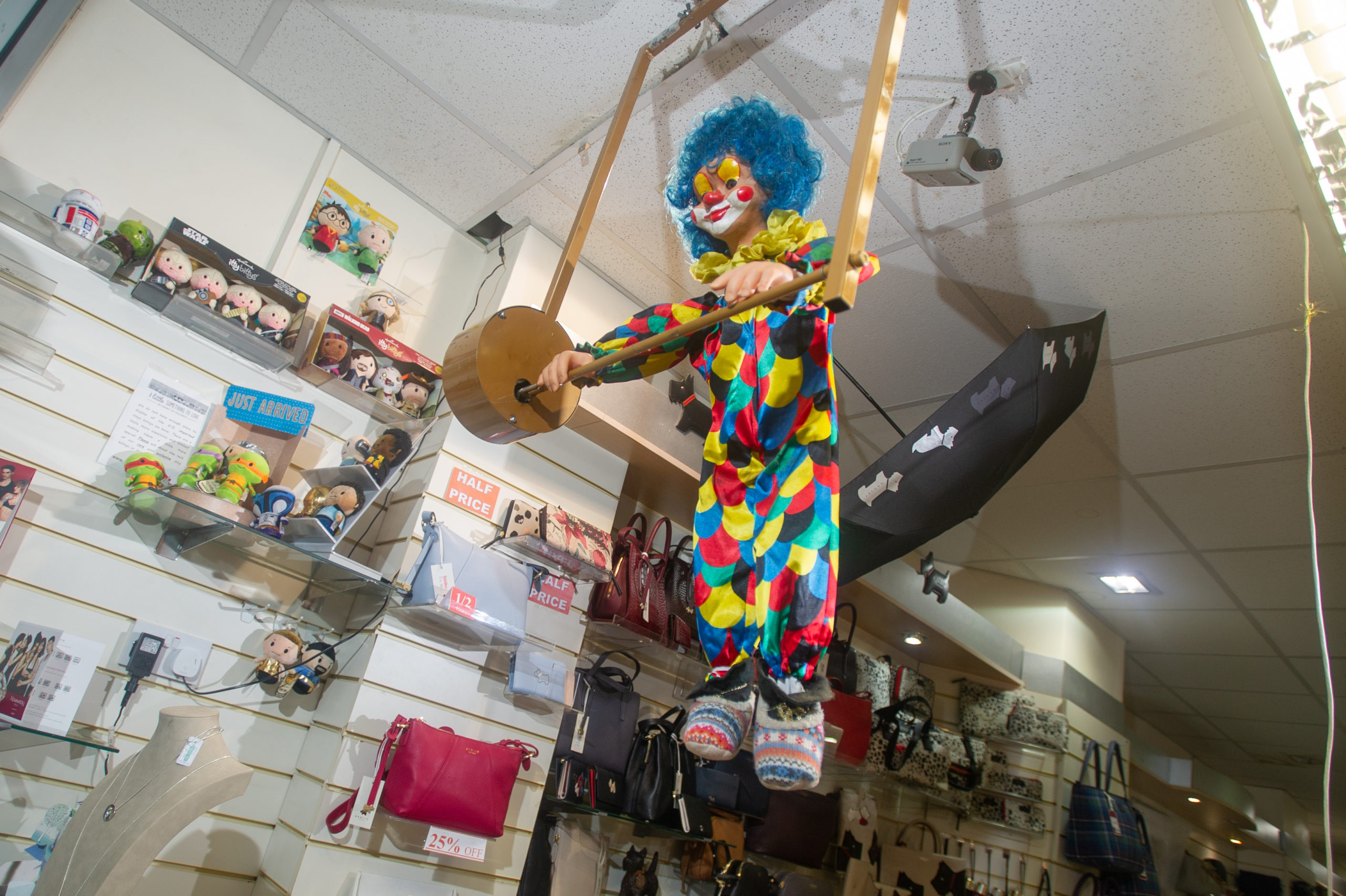 The clown back in place performing in the window of The Present Shop, Mercat Shopping Centre