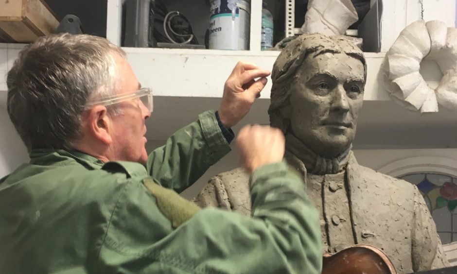 Sculptor David Annand at work on the Niel Gow memorial statue.