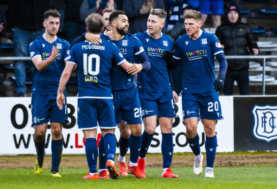 The Dundee players celebrate Kane Hemmings' second strike.