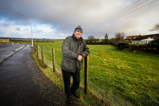 Local resident Jim Currie beside the field earmarked for development.
