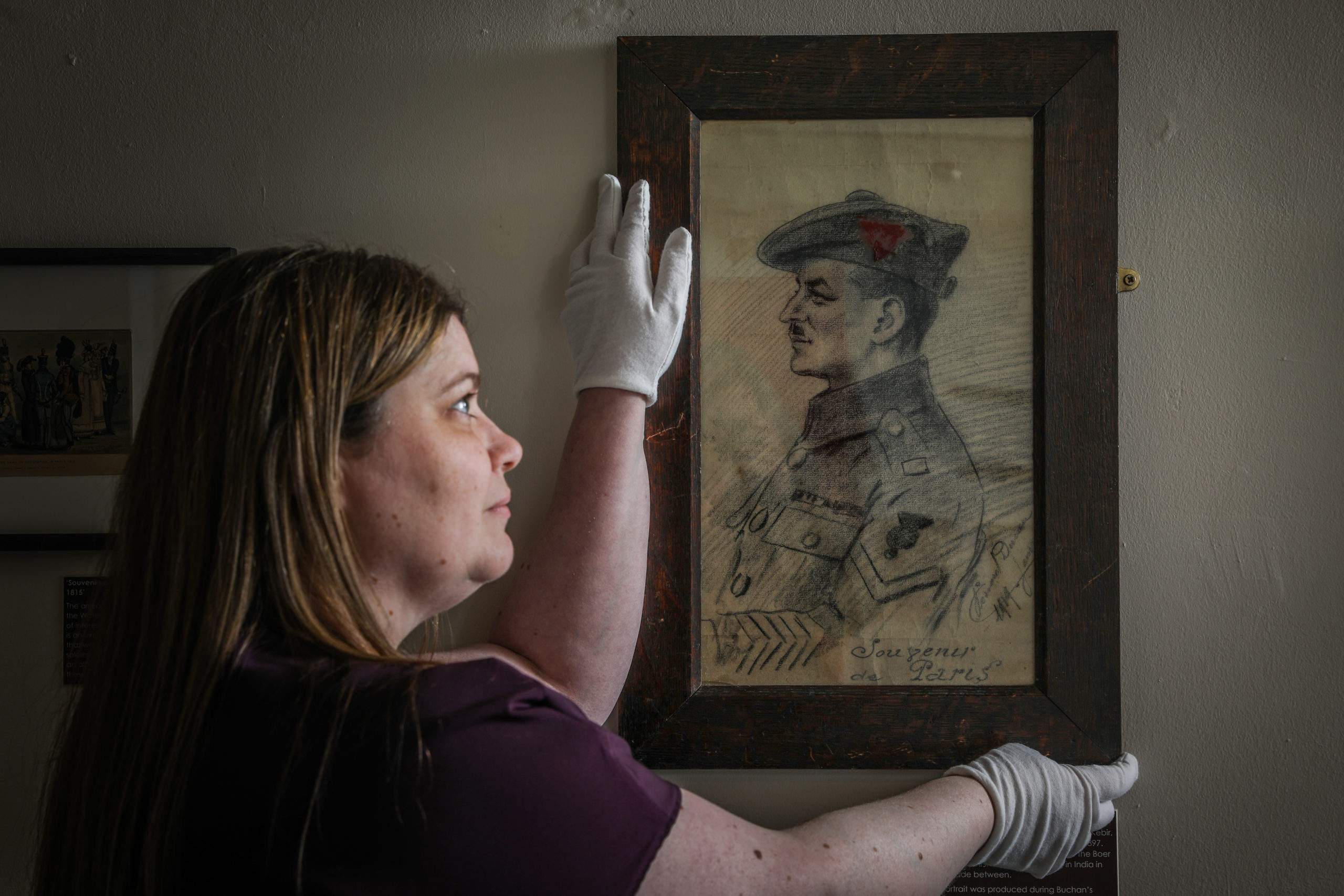 Museum Assistant Fiona Connah, with a portrait of David Buchan.