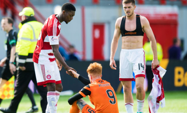 Rakish Bingham consoles Simon Murray after Hamilton beat Dundee United in the play-offs.
