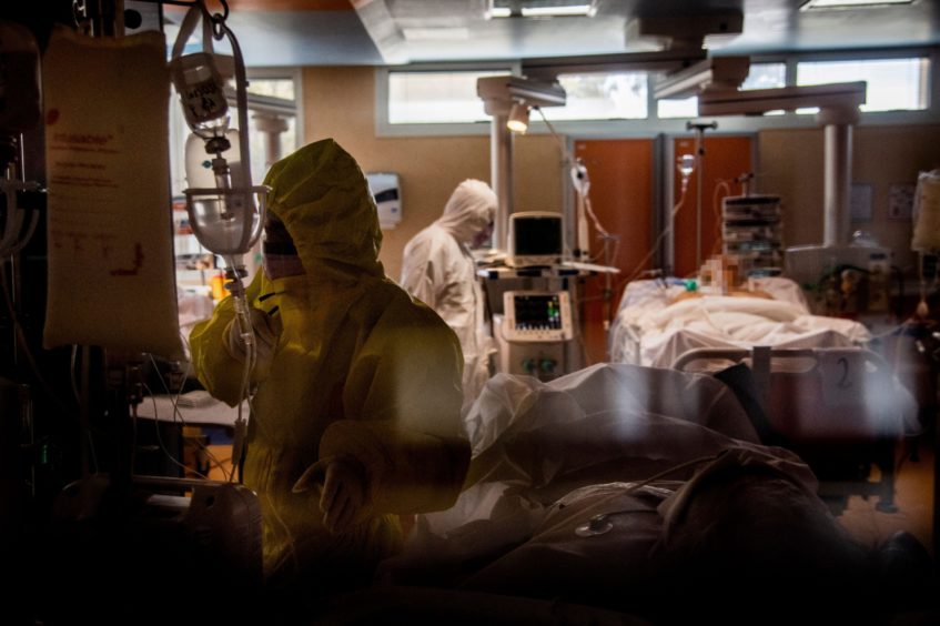 Nurses and doctors working on hospitalised coronavirus patients in the intensive care unit of a hospital in Rome. There are concerns that hospitals here might soon be facing similar pressures on intensive care units.
