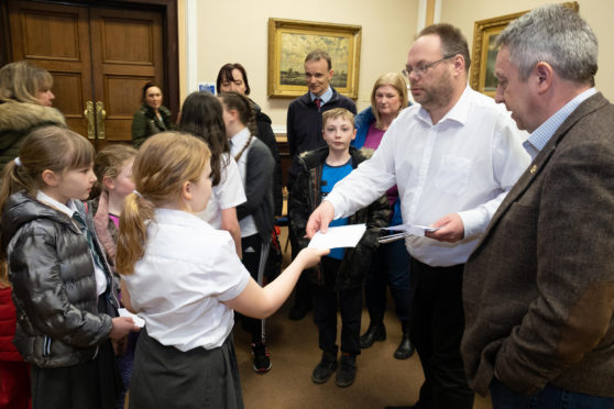 Children handing over their letters to Stewart Hunter, education convener at Dundee City Council