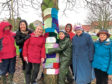 Members of the Cults and District SWI with the colourful scarves  they knitted for trees to mark the group's 100th anniversary.