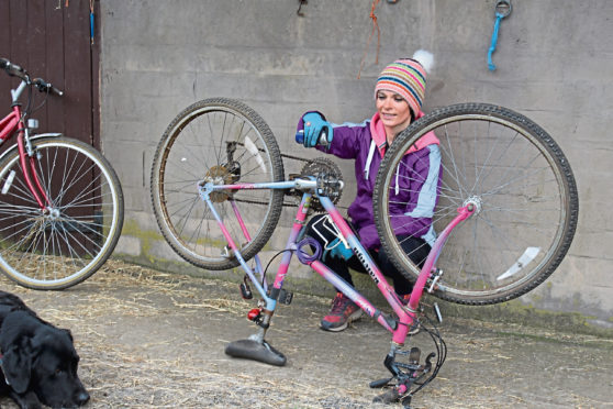 Gayle sprays some WD40 onto her very old bike.