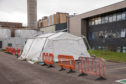A tent erected behind Raigmore Hospital in Inverness is beleived to be screening some drivers for coronavirus.